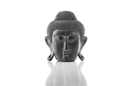 Buddha head on a white background, isolated and with reflectionの写真素材