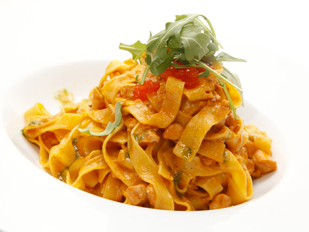 Delicious fresh pasta tossed with fresh tomatoes, basil and garlic. Shallow dof.の写真素材