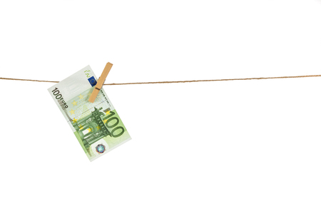 100 Euro banknote hanging on clothesline on white background. Money laundering conceptの写真素材