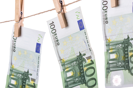 100 Euro banknotes hanging on clothesline on white background. Money laundering concept. Closeupの写真素材