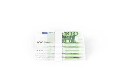 Stacks of 100 Euro Banknotes isolated on white backgroundの写真素材