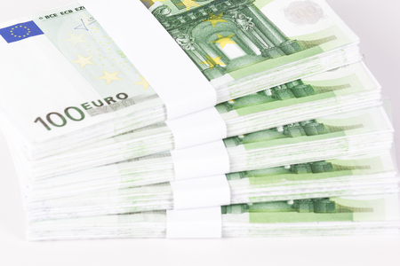Close-up of Stacks of 100 Euro Banknotes isolated on white backgroundの写真素材