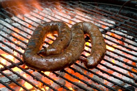 Tradtional South African braai barbecue borewors sausage on fireの写真素材