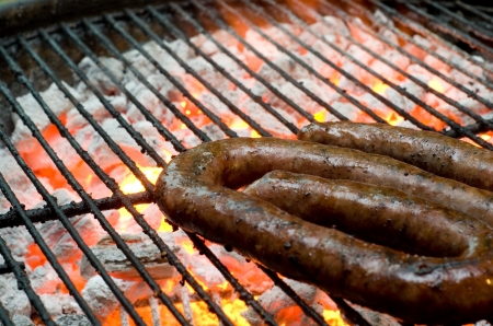 Tradtional South African braai barbecue borewors sausage on fireの写真素材