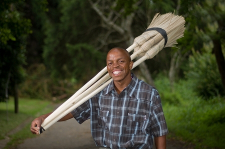 Stock photograph of a smiling black South African entrepreneur small business broom salesman in Hilton, Pietermaritzburg, Kwazulu-Natalの写真素材