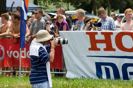MIDMAR DAM - 10 FEBRUARY 2013: An unidentified news photographer captures images at the 2013 Midmar Mile event near Howick, KwaZulu-Natal, South Africaのeditorial素材