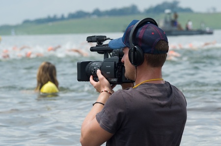 MIDMAR DAM - 10 FEBRUARY 2013: An unidentified television cameraman films footage of the main event of the Midmar Mile near Howick, KwaZulu-Natal, South Africaのeditorial素材