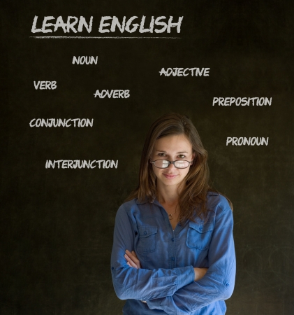 Learn English confident beautiful woman teacher chalk blackboard backgroundの写真素材