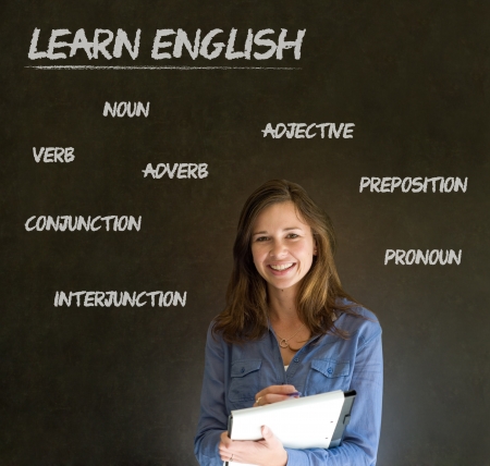 Learn English confident beautiful woman teacher chalk blackboard backgroundの写真素材