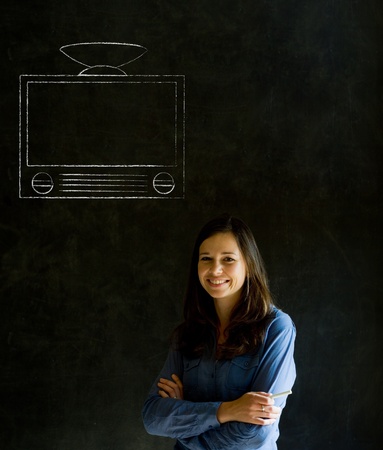 Businesswoman, teacher or student with with chalk tv television on blackboard backgroundの写真素材