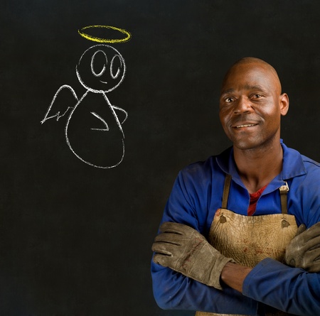 African black man industrial worker with chalk angel on blackboard backgroundの写真素材