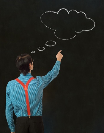 Nerd geek businessman student teacher with thought thinking chalk cloud on blackboard backgroundの写真素材