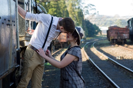 Retro hip hipster romantic love couple in vintage train settingの写真素材
