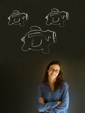 Businesswoman, student or teacher with chalk piggie banks  concept blackboard backgroundの写真素材