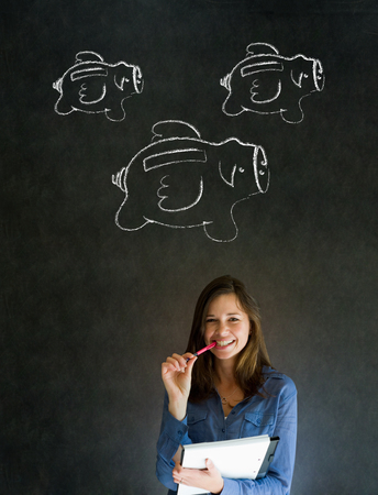 Businesswoman, student or teacher with chalk piggie banks  concept blackboard backgroundの写真素材
