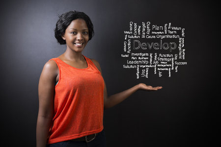 South African or African American woman teacher or student against blackboard background with chalk develop diagramの写真素材