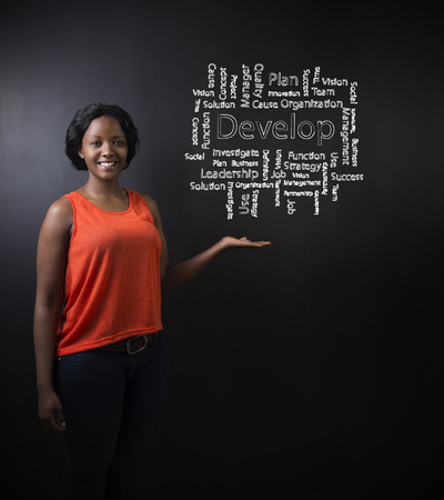 South African or African American woman teacher or student against blackboard background with chalk develop diagramの写真素材