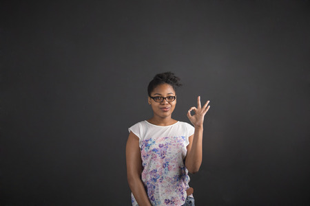 South African or African American black woman teacher or student holding up a perfect hand signal on...