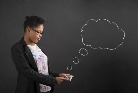 South African or African American black woman teacher or student holding a tablet with thought or...