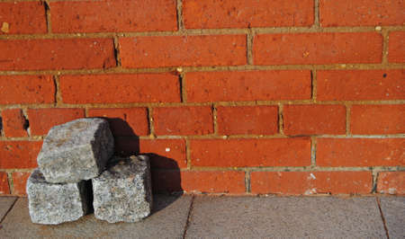 Three parallels stacked on the floor with a brick wall behindの写真素材