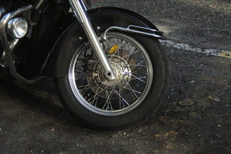 Wheel of a motorcycle in contrast to the road