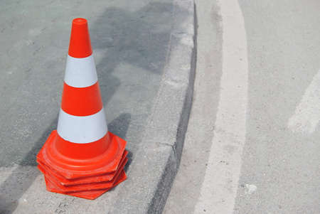 Tidy signal cones, stacked inside each other and placed on top of a sidewalk