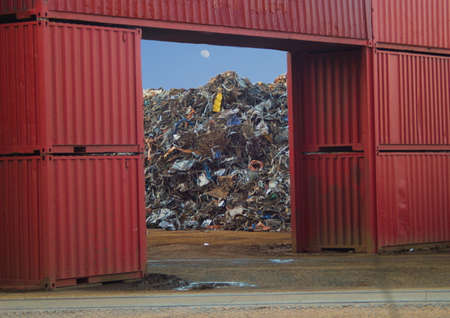 View of a pile of scrap between containersの写真素材