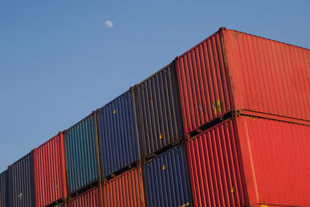 Nosky container line - stacked, blue and red containers with sky in the background and moon at daylight - export - importの写真素材