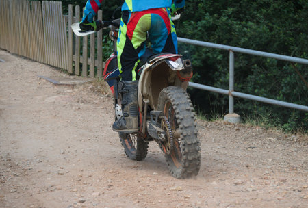 Motocross - man doing a mountain trail with a motorbike