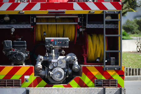 Rear and interior of a firefighter's rescue vehicle - water hoses, ladders and water pump -...