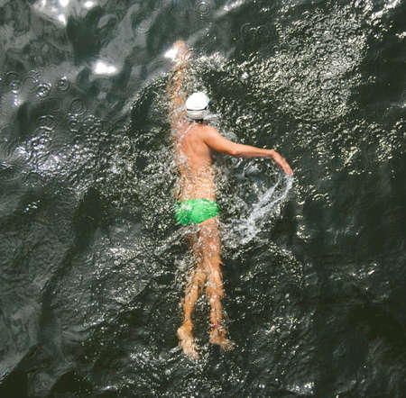 Swimmer swimming in river waterの写真素材