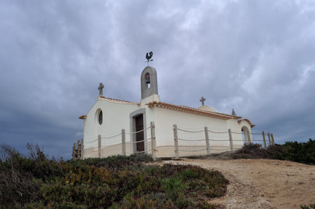 Restored chapel of Sant'Ana, SÃ£o Martinho do Porto, rainy day, dark sky with cloudsの写真素材