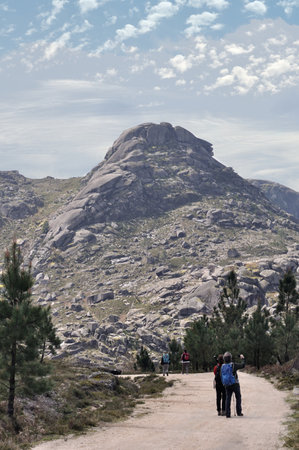 People walking on a mountain trail, sport, adventure, freedom, with cloudy sky, sierra scenery, gray tone colorsの写真素材