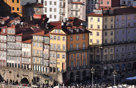 View to the riverside of the city of Oporto, old buildings with advertisements on the facadesのeditorial素材