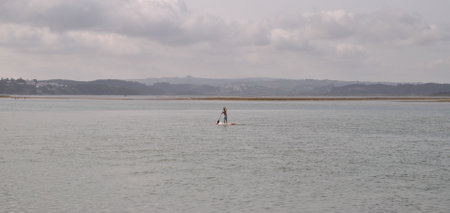 Person paddling on the sea horizonの写真素材