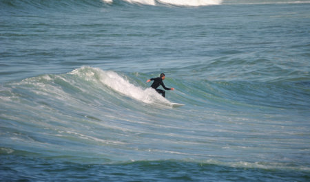 Surfer in action on the ocean wave on a sunny day.