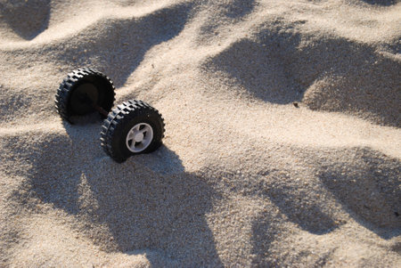 Truck toy wheels on the sand of a beach in the summer.の写真素材