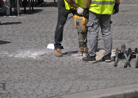 Worker with a jackhammer on the street in the city.の写真素材