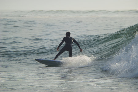 Surfer in action at the beach on a beautiful sunny day.の写真素材