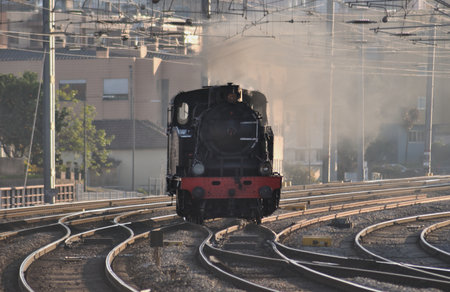Steam locomotive passing through the station in the morning, Portugal.