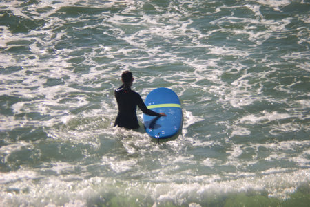 Surfer on the beach in Torrevieja, Alicante, Spain