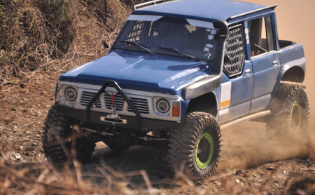 Modified and equipped all-terrain vehicle riding on a dirt track in a mountain, hobby and extreme...