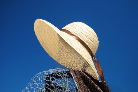 Silhouette of a person made of metal mesh, wearing clothes and a hatの写真素材