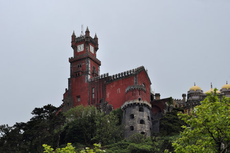 Red palace on top of a mountain, symbol of the city of Sintra in the town of Lisbon, capital of Portugal, Pena Palaceの写真素材