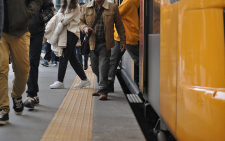 People waiting for the train at the station. Shallow depth of field.の写真素材