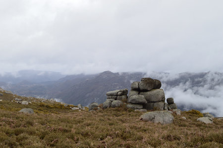 Mountain landscape with rocks and foggy clouds in Peneda Geres, Portugal.の写真素材