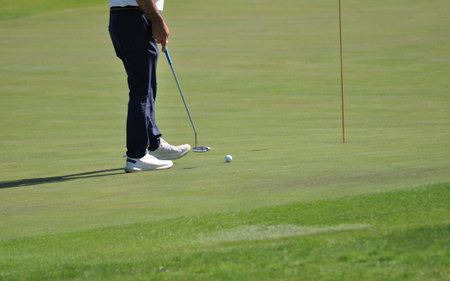 golf player in action on the green during the round of golfの写真素材
