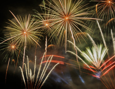 Colorful fireworks of various colors over night sky. Abstract background.の写真素材