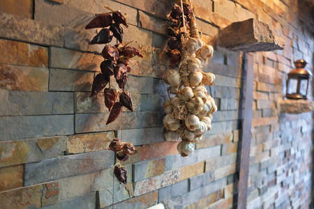 dry onions and peppers on the wall, cool idea, great decorationの写真素材