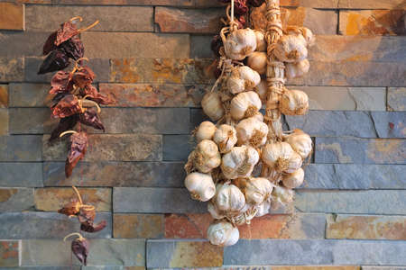 dry onions and peppers on the wall, cool idea, great decorationの写真素材